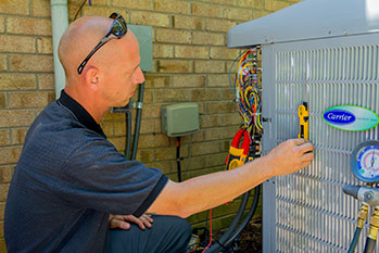 Technician inspecting HVAC unit